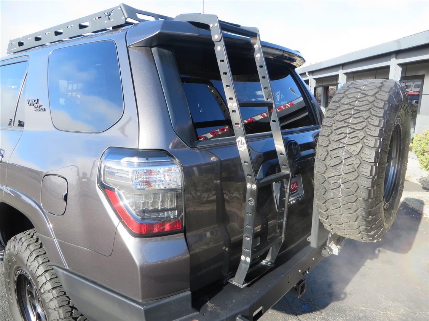 2021 grey /black Toyota 4Runner TRD Off-road Premium 4WD (JTERU5JR3M5) with an 4.0L V6 DOHC 24V engine, 5A transmission, located at 2630 Grass Valley Highway, Auburn, CA, 95603, (530) 508-5100, 38.937893, -121.095482 - Featuring Icon suspension, C4 front bumper, Victory 4x4 rear bumper with spare tire carrier, C4 ladder, Victory 4x4 roof rack, Victory 4x4 rock sliders, Baja designs LED's, 17'' KMC wheels, Maxxis Razr AT tires, and a Victory 4x4 rear cargo Molle panel. - Photo#16