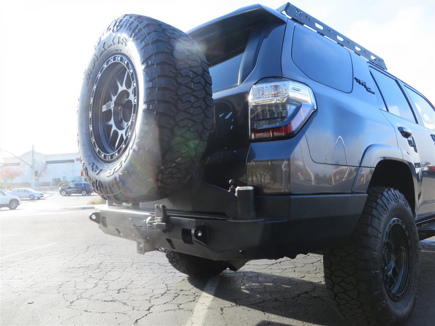 2021 grey /black Toyota 4Runner TRD Off-road Premium 4WD (JTERU5JR3M5) with an 4.0L V6 DOHC 24V engine, 5A transmission, located at 2630 Grass Valley Highway, Auburn, CA, 95603, (530) 508-5100, 38.937893, -121.095482 - Featuring Icon suspension, C4 front bumper, Victory 4x4 rear bumper with spare tire carrier, C4 ladder, Victory 4x4 roof rack, Victory 4x4 rock sliders, Baja designs LED's, 17'' KMC wheels, Maxxis Razr AT tires, and a Victory 4x4 rear cargo Molle panel. - Photo#18