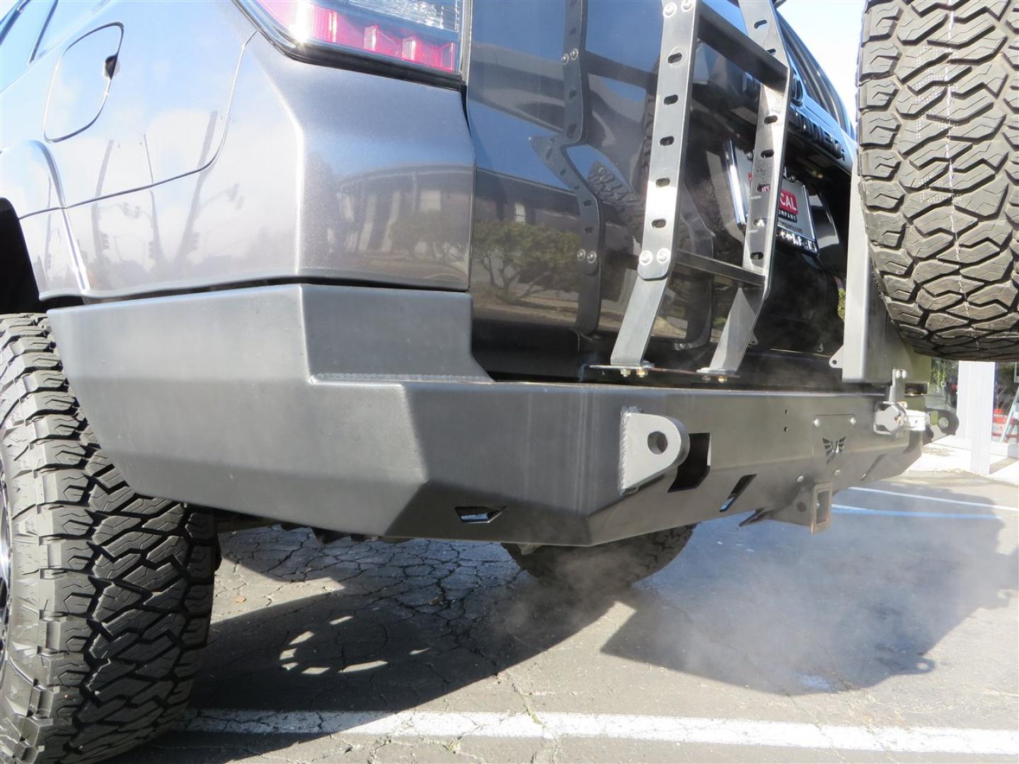 2021 grey /black Toyota 4Runner TRD Off-road Premium 4WD (JTERU5JR3M5) with an 4.0L V6 DOHC 24V engine, 5A transmission, located at 2630 Grass Valley Highway, Auburn, CA, 95603, (530) 508-5100, 38.937893, -121.095482 - Featuring Icon suspension, C4 front bumper, Victory 4x4 rear bumper with spare tire carrier, C4 ladder, Victory 4x4 roof rack, Victory 4x4 rock sliders, Baja designs LED's, 17'' KMC wheels, Maxxis Razr AT tires, and a Victory 4x4 rear cargo Molle panel. - Photo#17