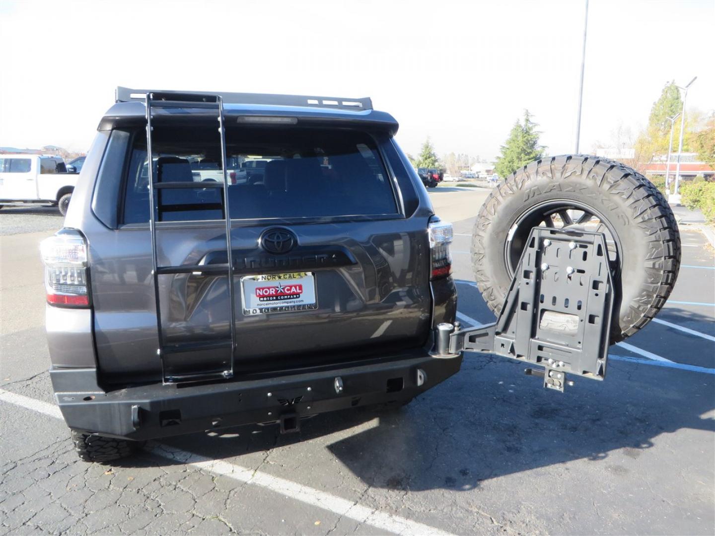2021 grey /black Toyota 4Runner TRD Off-road Premium 4WD (JTERU5JR3M5) with an 4.0L V6 DOHC 24V engine, 5A transmission, located at 2630 Grass Valley Highway, Auburn, CA, 95603, (530) 508-5100, 38.937893, -121.095482 - Featuring Icon suspension, C4 front bumper, Victory 4x4 rear bumper with spare tire carrier, C4 ladder, Victory 4x4 roof rack, Victory 4x4 rock sliders, Baja designs LED's, 17'' KMC wheels, Maxxis Razr AT tires, and a Victory 4x4 rear cargo Molle panel. - Photo#19