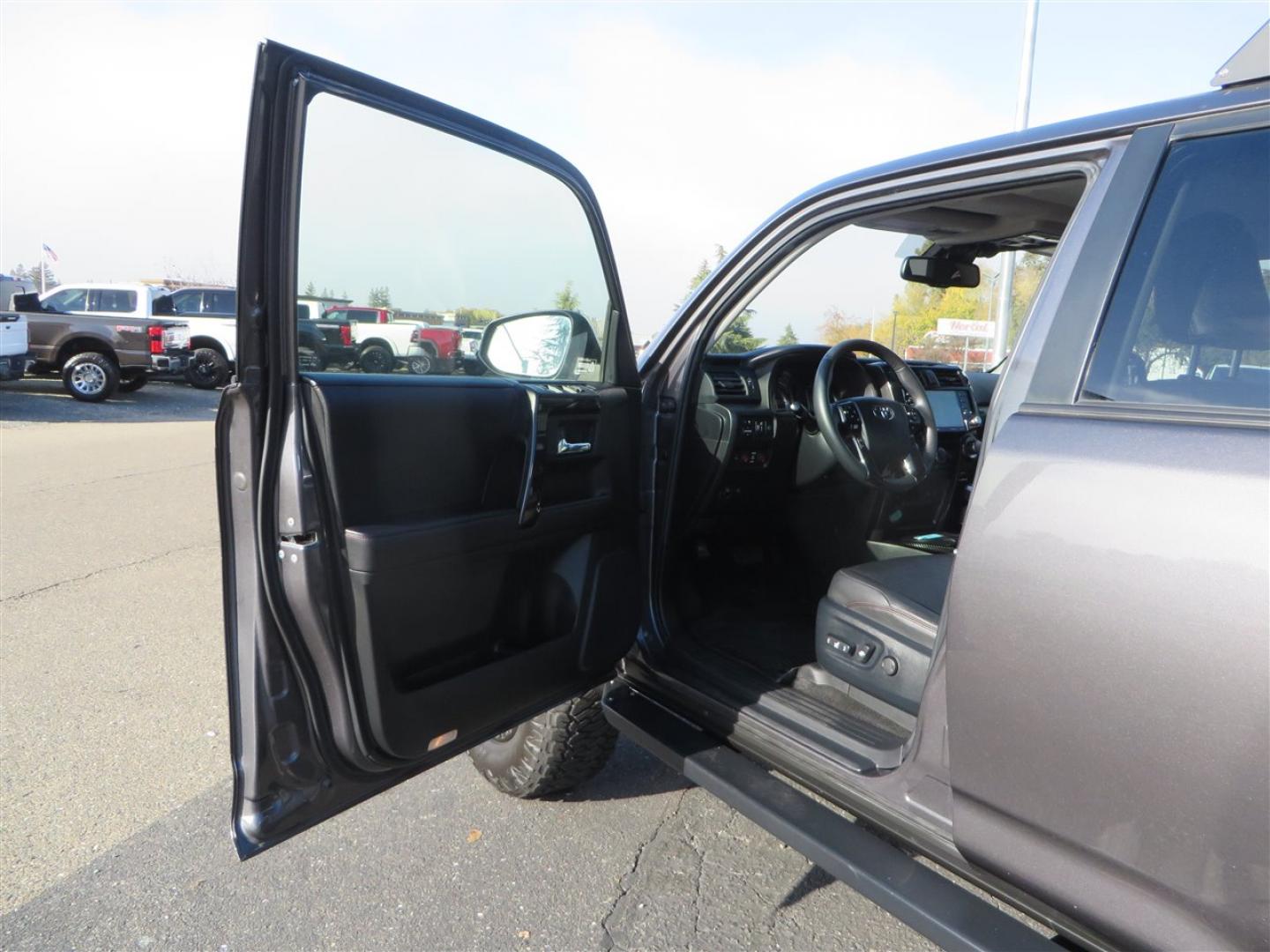 2021 grey /black Toyota 4Runner TRD Off-road Premium 4WD (JTERU5JR3M5) with an 4.0L V6 DOHC 24V engine, 5A transmission, located at 2630 Grass Valley Highway, Auburn, CA, 95603, (530) 508-5100, 38.937893, -121.095482 - Featuring Icon suspension, C4 front bumper, Victory 4x4 rear bumper with spare tire carrier, C4 ladder, Victory 4x4 roof rack, Victory 4x4 rock sliders, Baja designs LED's, 17'' KMC wheels, Maxxis Razr AT tires, and a Victory 4x4 rear cargo Molle panel. - Photo#22