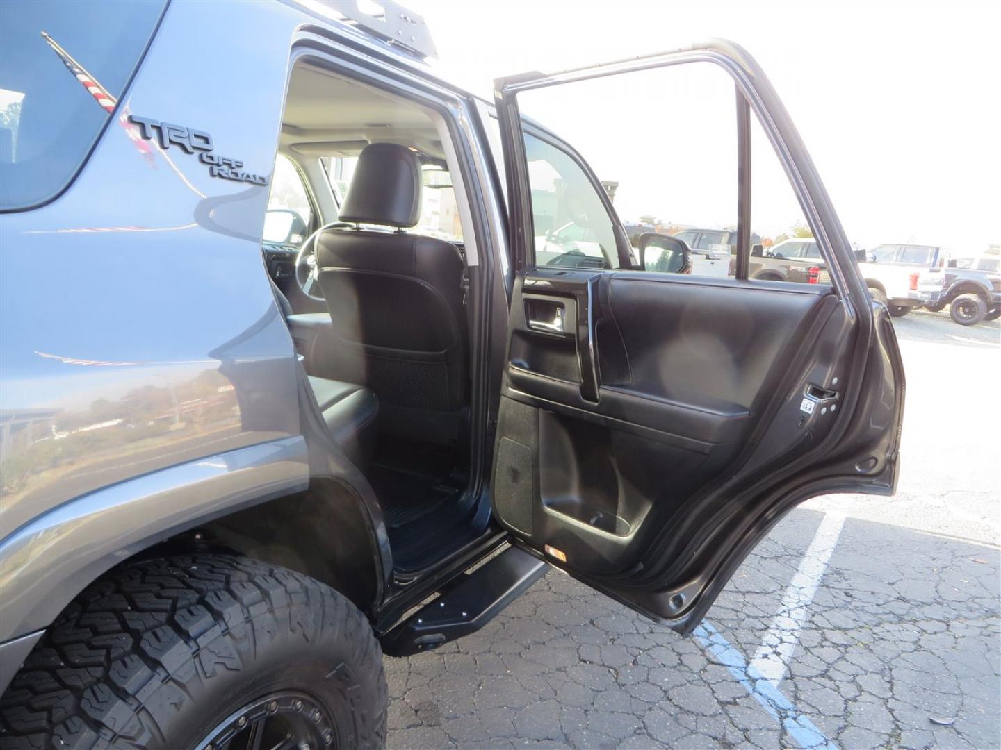 2021 grey /black Toyota 4Runner TRD Off-road Premium 4WD (JTERU5JR3M5) with an 4.0L V6 DOHC 24V engine, 5A transmission, located at 2630 Grass Valley Highway, Auburn, CA, 95603, (530) 508-5100, 38.937893, -121.095482 - Featuring Icon suspension, C4 front bumper, Victory 4x4 rear bumper with spare tire carrier, C4 ladder, Victory 4x4 roof rack, Victory 4x4 rock sliders, Baja designs LED's, 17'' KMC wheels, Maxxis Razr AT tires, and a Victory 4x4 rear cargo Molle panel. - Photo#61