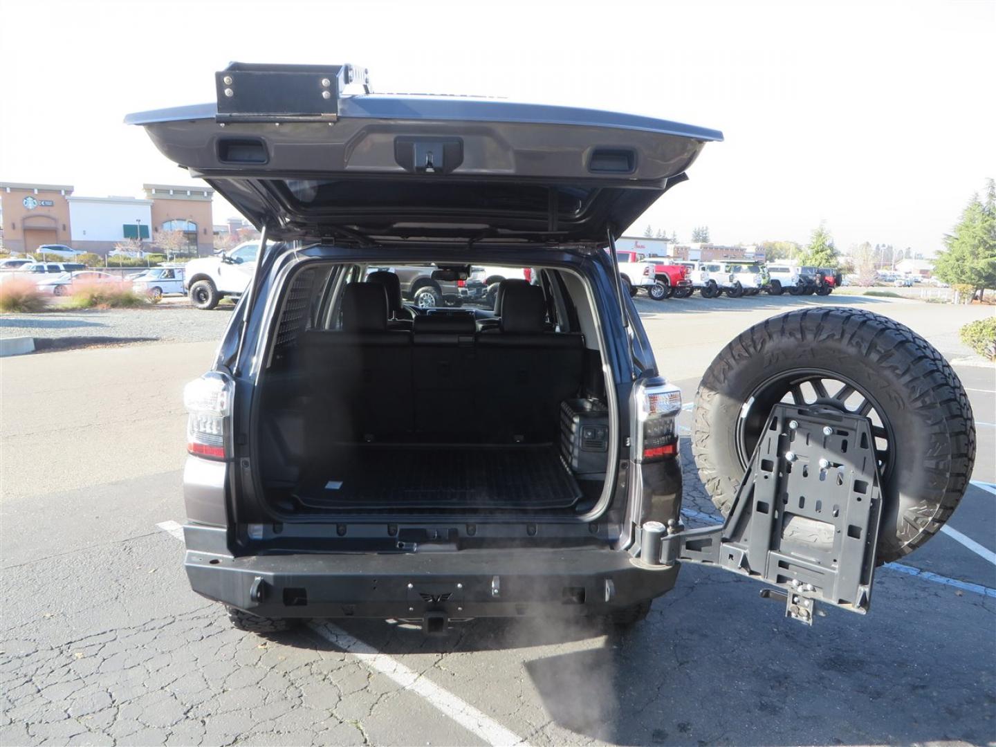 2021 grey /black Toyota 4Runner TRD Off-road Premium 4WD (JTERU5JR3M5) with an 4.0L V6 DOHC 24V engine, 5A transmission, located at 2630 Grass Valley Highway, Auburn, CA, 95603, (530) 508-5100, 38.937893, -121.095482 - Featuring Icon suspension, C4 front bumper, Victory 4x4 rear bumper with spare tire carrier, C4 ladder, Victory 4x4 roof rack, Victory 4x4 rock sliders, Baja designs LED's, 17'' KMC wheels, Maxxis Razr AT tires, and a Victory 4x4 rear cargo Molle panel. - Photo#68